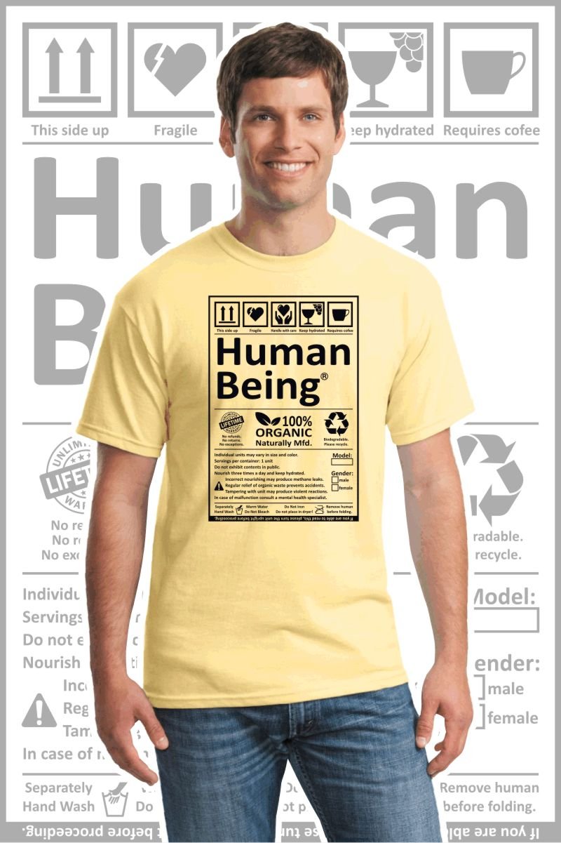 Male wearing a light yellow printed T Shirt with a black design of a Human Being label.